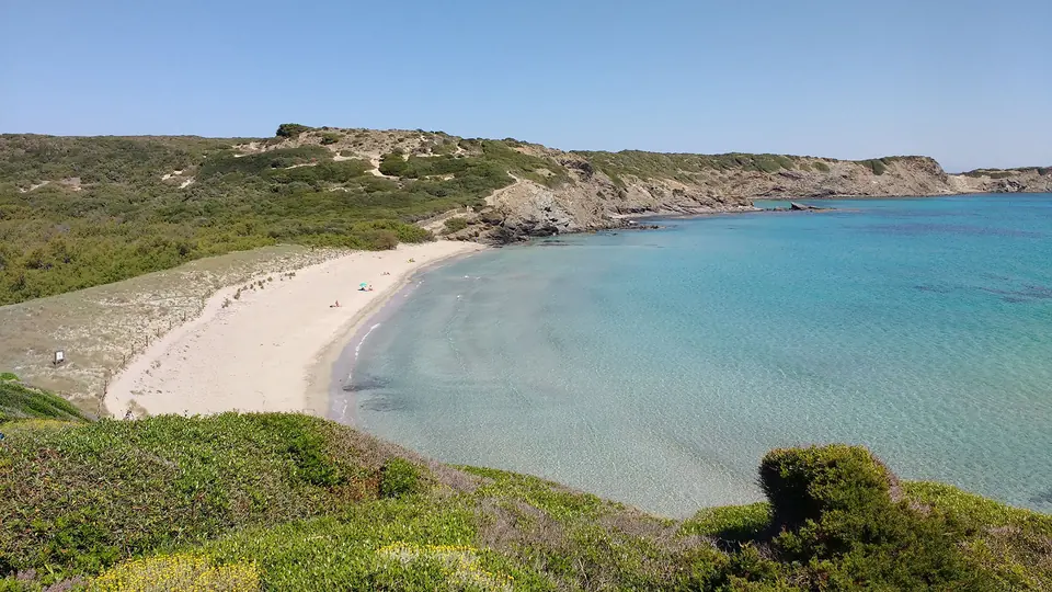 Cala en Tortuga: platja de sorra clara i aigües turquesa entre turons